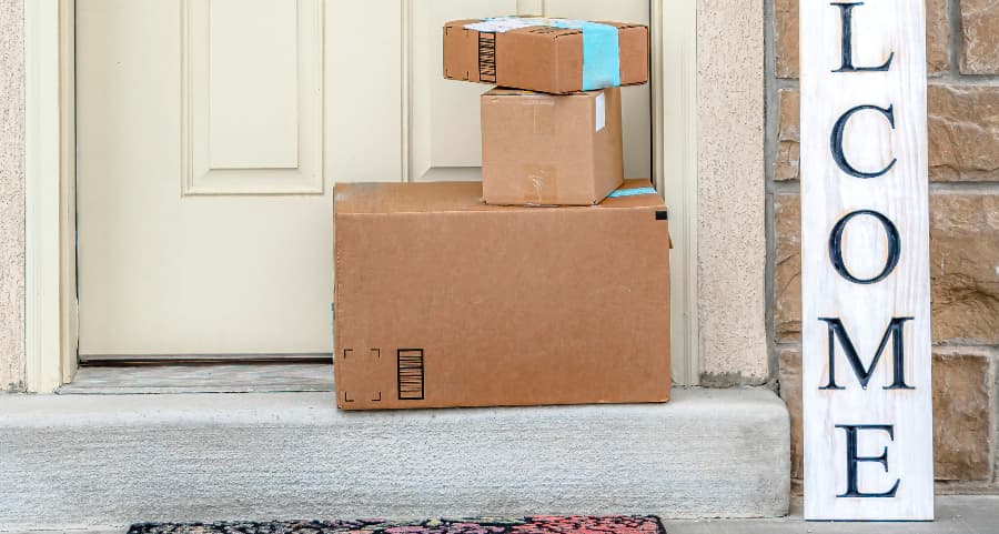 Boxes by the door of a residence with a welcome sign in Newark